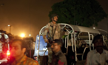 Pakistani security troops rush to Jinnah International Airport in Karachi