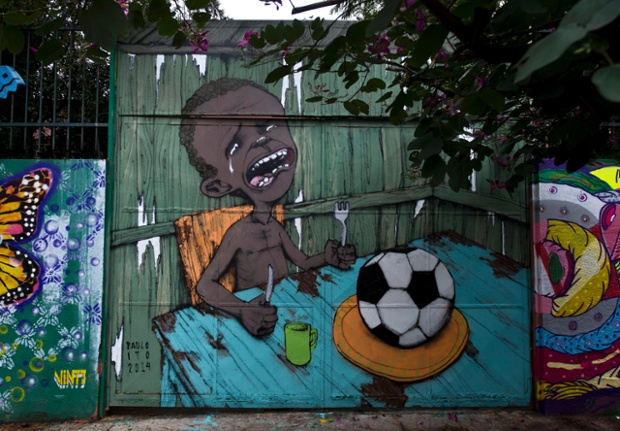 Graffiti painted by Brazilian street artist Paulo Ito of depicting a starving child with nothing to eat but a football.