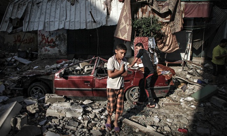 Palestinian children inspect damage from Israeli air strikes in the Gaza Strip.