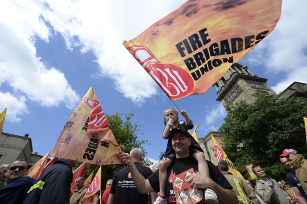 Public sector worker Scott Clarke with six-year-old daughter Amber Clarke during a march through Newcastle city centre as they take part in the one-day walkout as part of bitter disputes over pay, pensions, jobs and spending cuts.