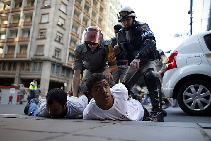 20 Photos: Riot policemen detain two men during a protest in Porto Alegre