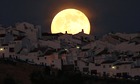 The Supermoon rises over houses in Spain
