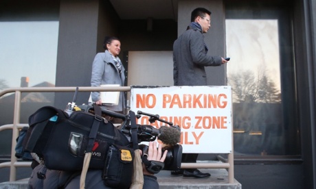 Tasmanian PUP Senator Jacqui Lambie and Western Australian Dio Wang wait for the door to be open to attend a meeting at their press club offices this morning to discuss the final amendments to the Rabin repeal legislation, Monday 14th July 2014