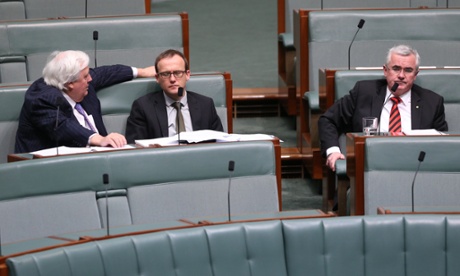 The cross benches Clive Palmer talks with Adam Bandt and Andrew Wilkie during during debate on the carbon tax repeal amendments legislation in the House of Representatives in Parliament House this afternoon, Monday 14th July 2014.