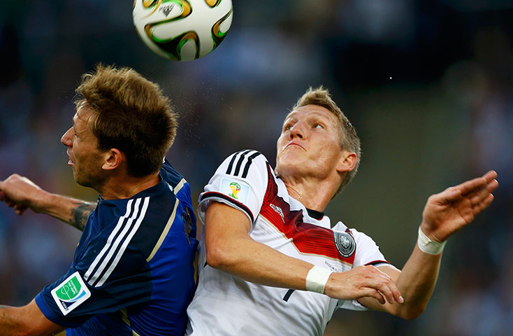 Schweinsteigar's Final: Argentina's Biglia jumps for the ball with Germany's Schweinsteiger