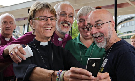 Church of England Clerics take a selfie as they celebrate after the vote to allow female bishops