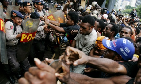 Papuan activists clash with police guarding a building housing the office of US mining giant Freeport in 2006.