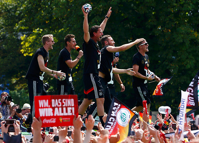berlin victory parade: Germany's national soccer team players wave from a stage