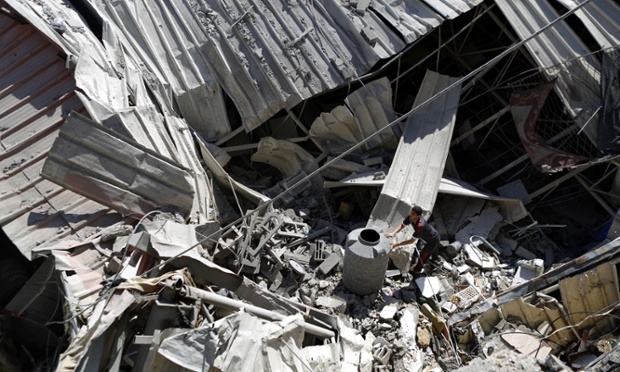 A man inspects damage following an Israeli air strike in Gaza city