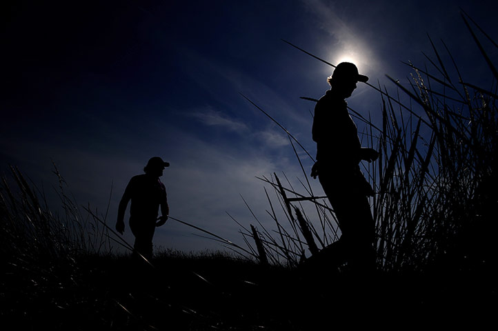open golf day 1: Phil Mickelson and Ernie Els, right walk off the 13th tee 