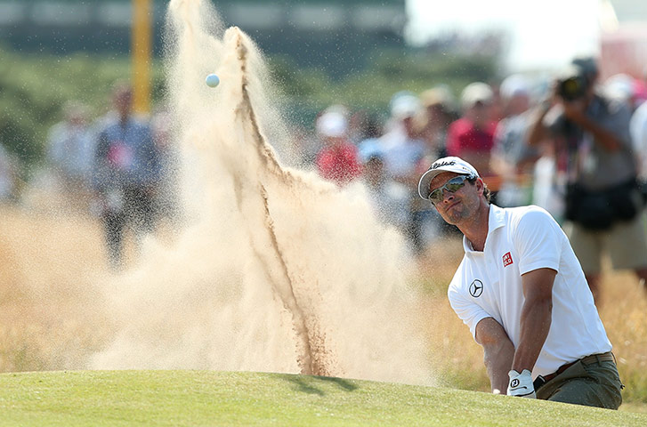 open golf day 1: Adam Scott plays out of a green-side bunker on the 7th 
