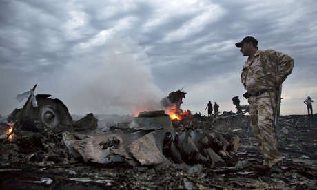 People walk among the debris of Malaysia Airlines flight MH17