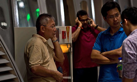 Relatives of passengers on Malaysia Airlines flight MH17 await information at Kuala Lumpur airport