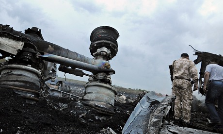 A Ukrainian serviceman stands next to the wrecked undercarriage of Malaysia Airline flight MH17