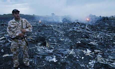 Security personnel at the crash site of the Malaysia Airlines MH17 flight from Amsterdam to Kuala Lumpur.