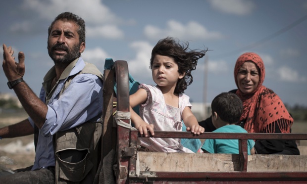 A Palestinian family who fled their homes is en route to seek shelter in a UN school in Khan Younis, central Gaza. Israel have launched a ground offensive and you can follow events in our live blog.