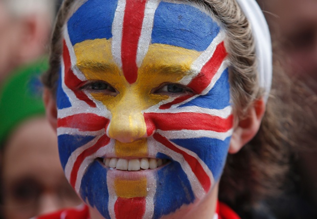 A cycling fan has the Union Jack painted on her face as she watches the first stage of the Tour de France cycling race over 190.5 kilometers (118.4 miles) with start in Leeds and finish in Harrogate, England.