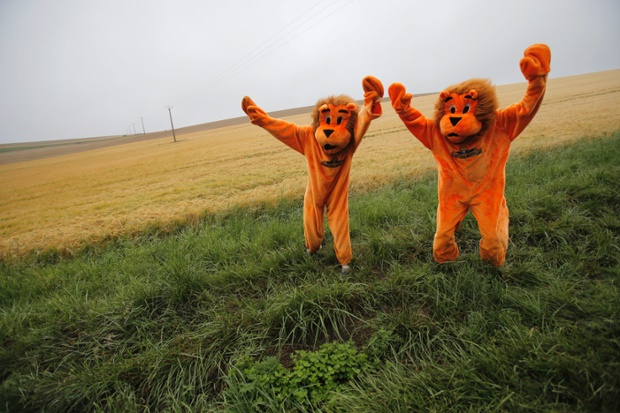 Two cycling fans in disguise wait for the pack to pass during the sixth stage of the Tour de France cycling race over 194 kilometers (120.5 miles) with start in Arras and finish in Reims, France