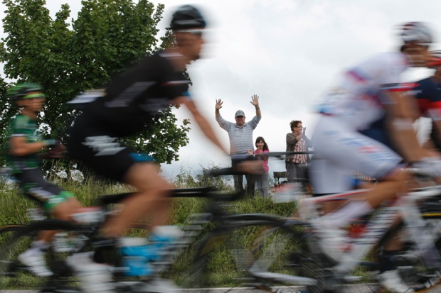 Spectators cheer as riders pass during the eighth stage of the Tour de France cycling race over 161 kilometers (100 miles) with start in Tomblaine and finish in Gerardmer, France.