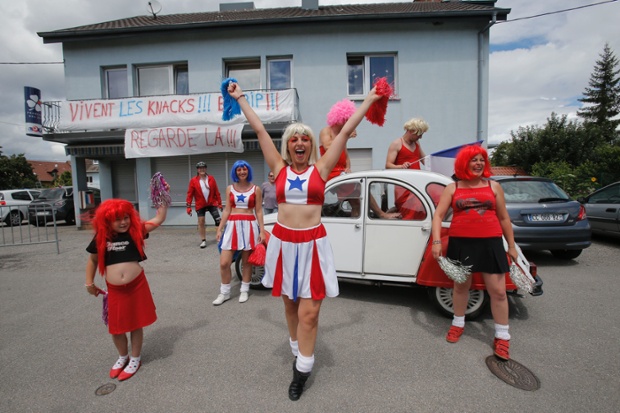 Spectators cheer as they wait for the riders to pass during the tenth stage of the Tour de France cycling race over 161.5 kilometers (100.4 miles) with start in Mulhouse and finish in La Planche des Belles Filles, France.