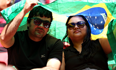 Fans in Brazil take cover from the sun