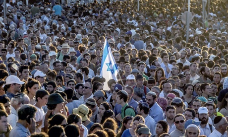 Tens of thousands Israelis attend the joint funeral of Gilad Shaer, 16, Naftali Frenkel, 16, and Eyal Ifrach, 19, in the central Israeli town of Modiin on July 1, 2014.