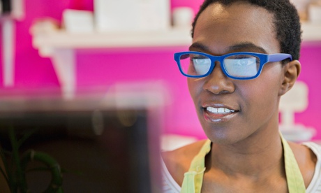 Female small business owner using computer in store