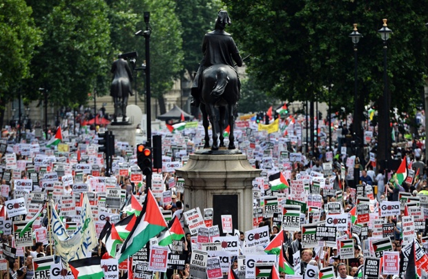 Tens of thousands of pro-Palestinian demonstrators march up Whitehall towards the Israeli embassy during a protest in London.