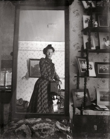 An unidentified Edwardian woman taking a selfie with a Kodak Brownie box camera around 1900