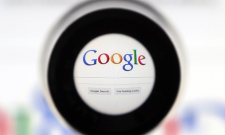 A Google search page is seen through a magnifying glass.