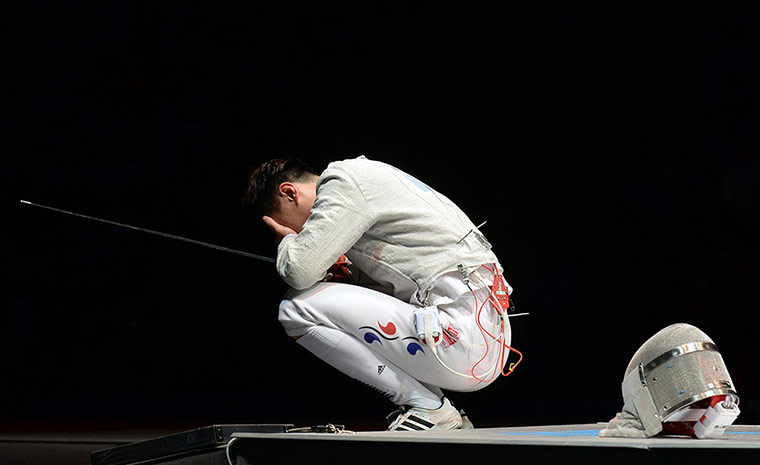 Fencing World: Bongil Gu of South Korea reacts after he
