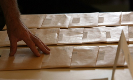 A teacher adjusts the envelopes containing his pupils GCSE results in Bath, 2007