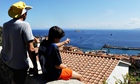 People watch Costa Concordia leaving Giglio 