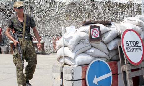 A pro-Russian separatist mans a checkout 25 kilometers from the city of Donetsk.