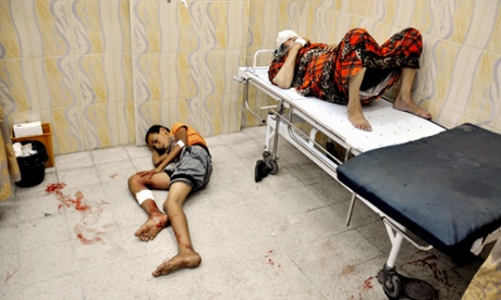 Palestinians sit at a hospital in the northern Gaza Israel-Gaza conflict, Gaza Strip, Palestinian Territories - 24 Jul 2014.