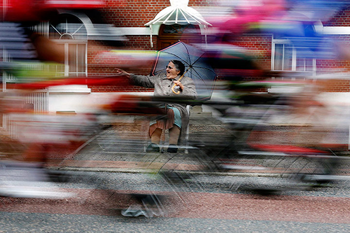 Best TDF 2014: An elderly woman cheers as the pack of riders cycles past