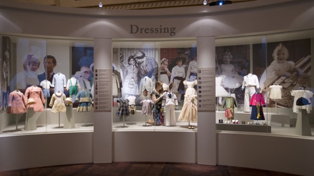 A display of royal children's outfits in the Ball Supper Room of Buckingham Palace