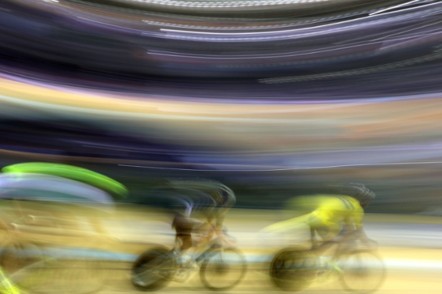 Riders warm-up ahead of the morning session races in the Sir Chris Hoy Velodrome during the 2014 Commonwealth Games in Glasgow, Scotland.