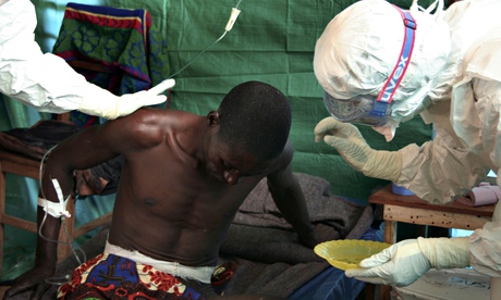 Staff of the medical charity Médecins Sans Frontières treat a man suspected of contracting ebola