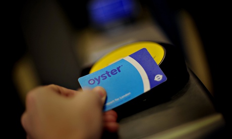 Passenger swipes an Oyster card on the reader