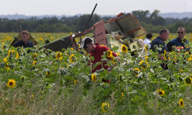 Dutch and Australian investigators examine pieces of the crashed Malaysia Airlines Flight 17 in the village of Rassipne, Donetsk region, eastern Ukraine.