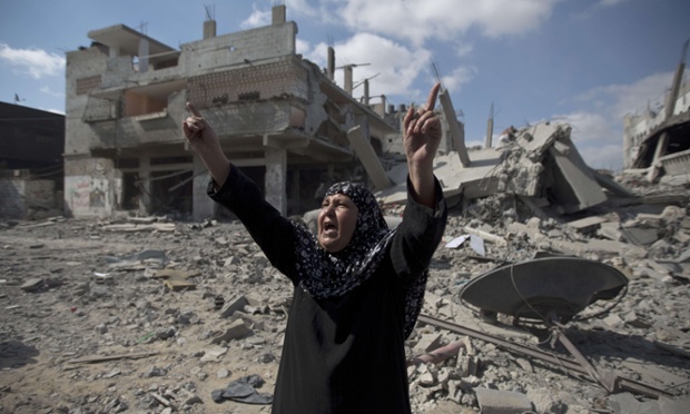 A Palestinian woman looks at the rubble of destroyed buildings in the Shejaiya district of Gaza City.