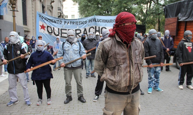 Buenos Aires, Argentina: Masked supporters of the Palestinians demonstrate outside the Israeli embassy