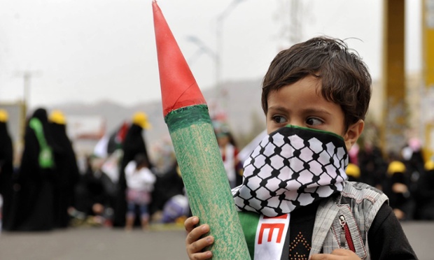 Sana'a, Yemen: A child holds a model of a missile during a protest