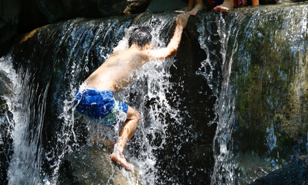 Tokyo, Japan: Children play in the water fountain at Asuka park