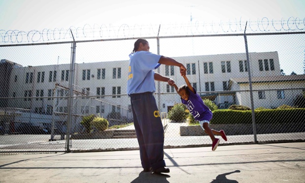 California, USa: Pharaoh Haywood plays with his daughter during a visiting day to Folsom State Prison.
