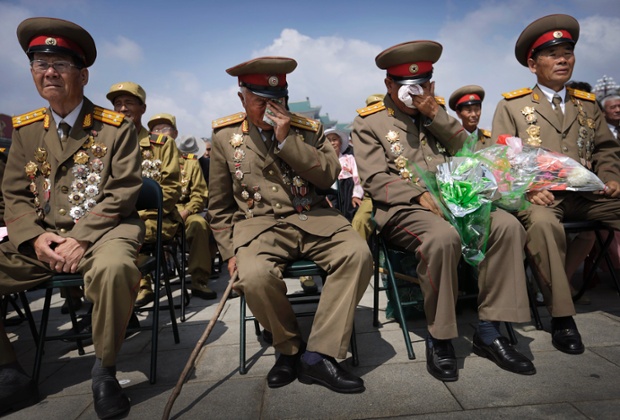 Emotional North Korean war veterans watch a parade celebrating the anniversary at Kim Il Sung Square.