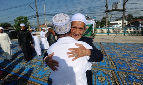 Thai Muslims hug each other after morning prayers at a mosque on the first day of Eid al-Fitr celebrations in Thailand's southern province of Narathiwat, 28 July, 2014.