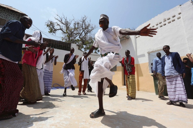 Mogadishu, Somalia: a man performs a traditional dance in celebration after attending Eid al-Fitr prayers.
