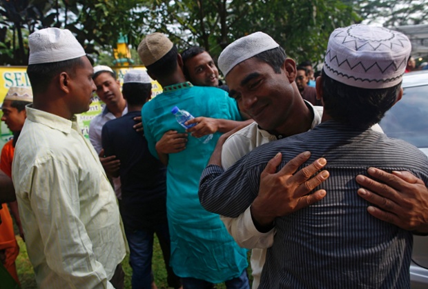 Singapore: Migrant workers from Bangladesh embrace after Hari Raya prayers at Masjid Pertempatan Melayu Sembawang, one of the last kampung (village) mosques untouched by development.